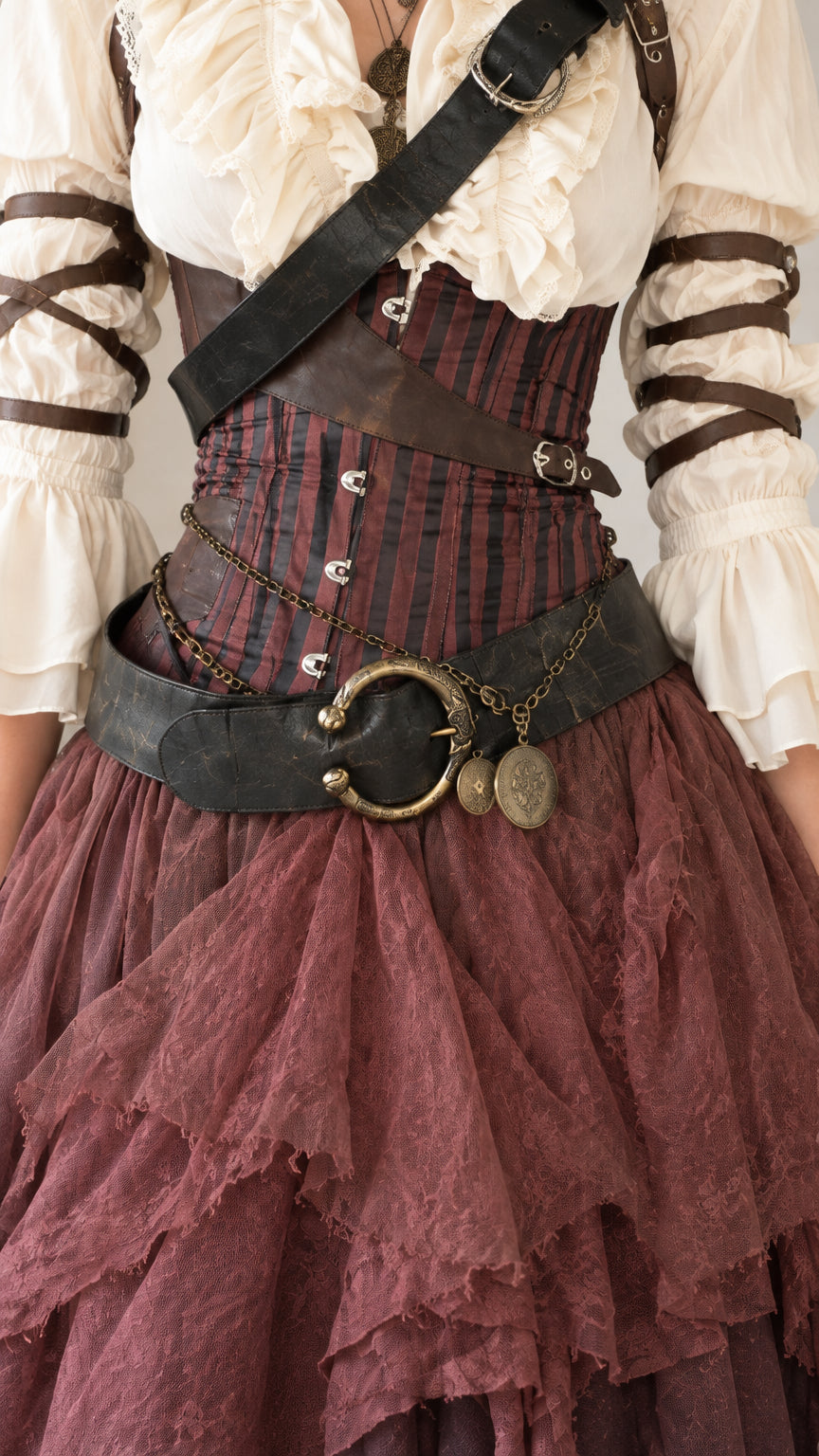 Close-up detail of pinstriped underbust corset and layered ruffled skirt
