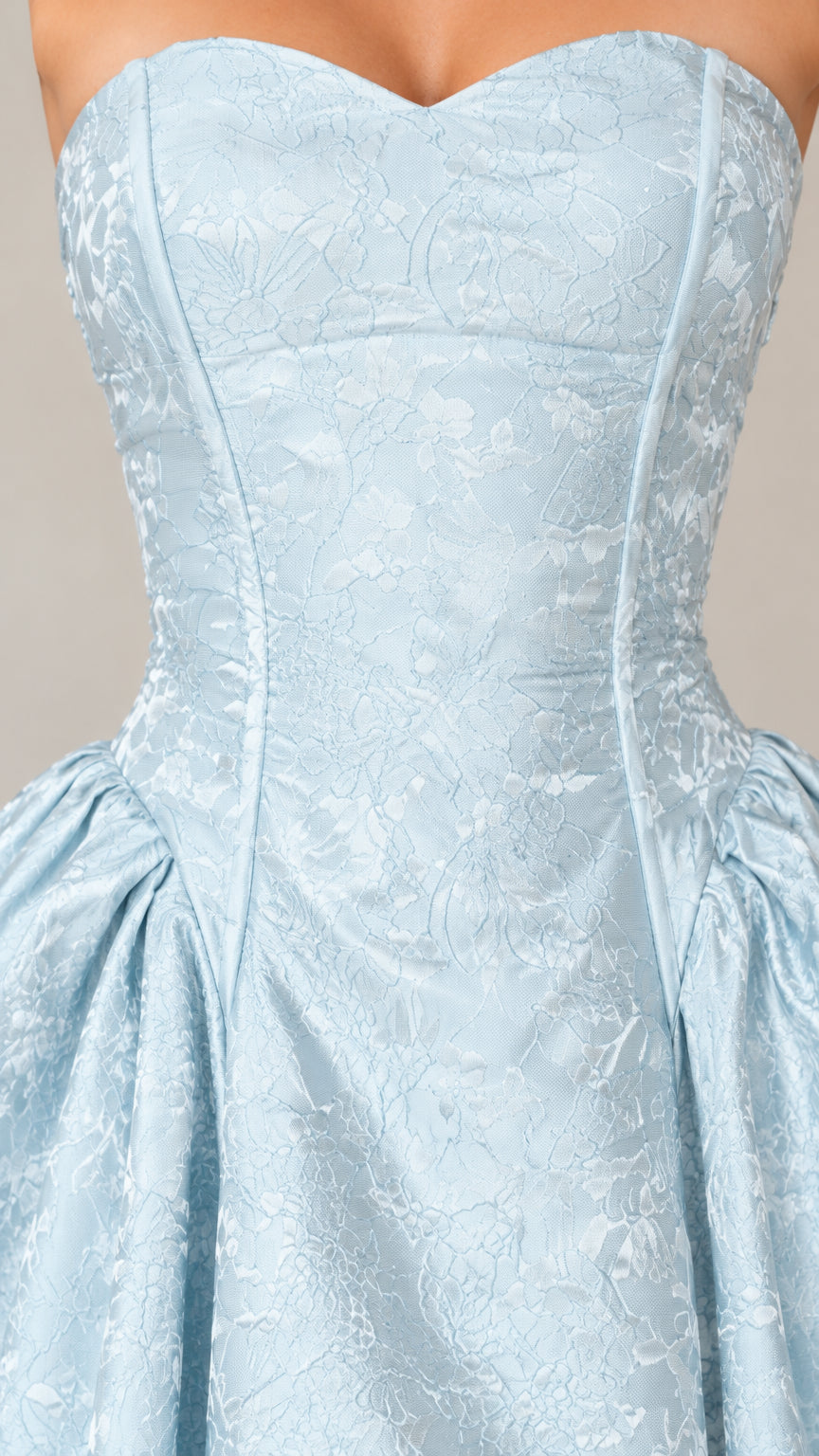 Close-up of the light blue sweetheart neckline and floral texture