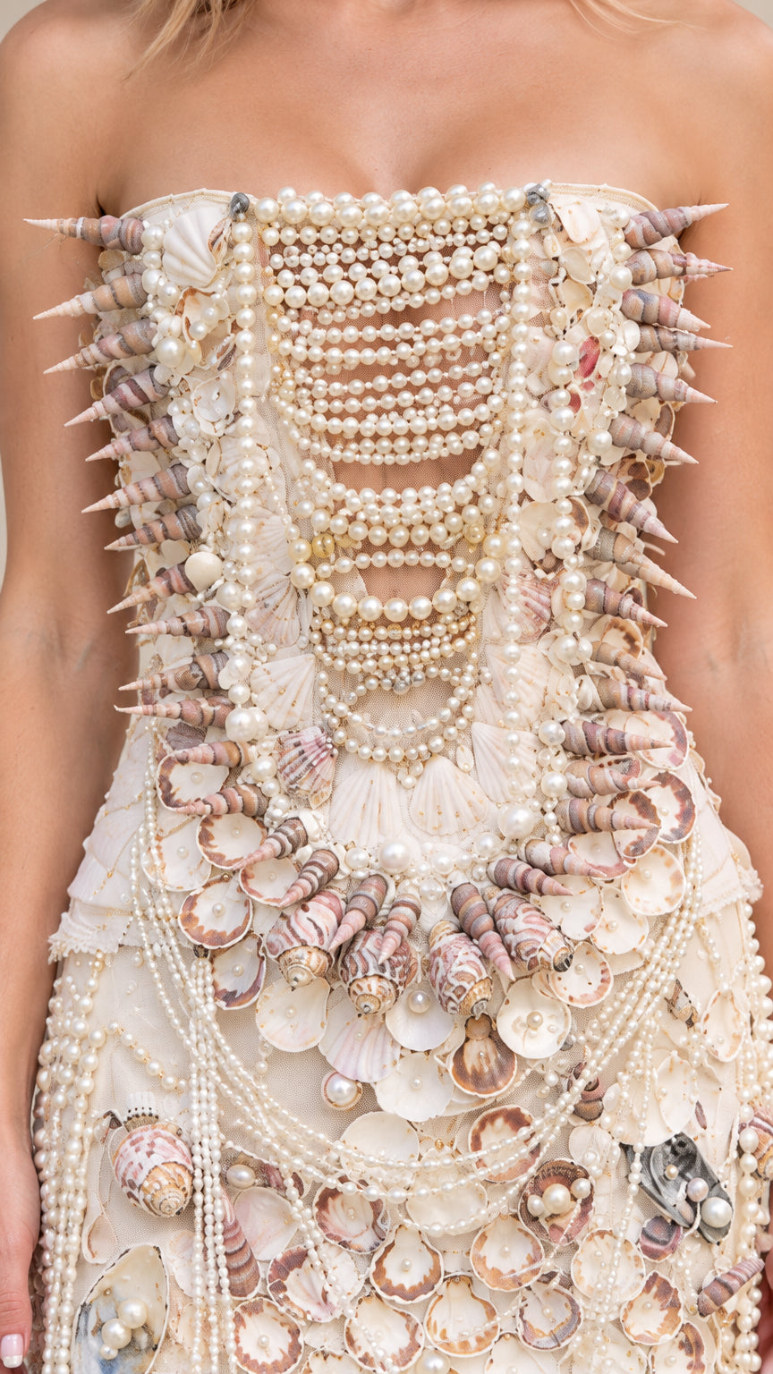 Close-up detail of bodice featuring intricate seashell placement and layered pearl strands