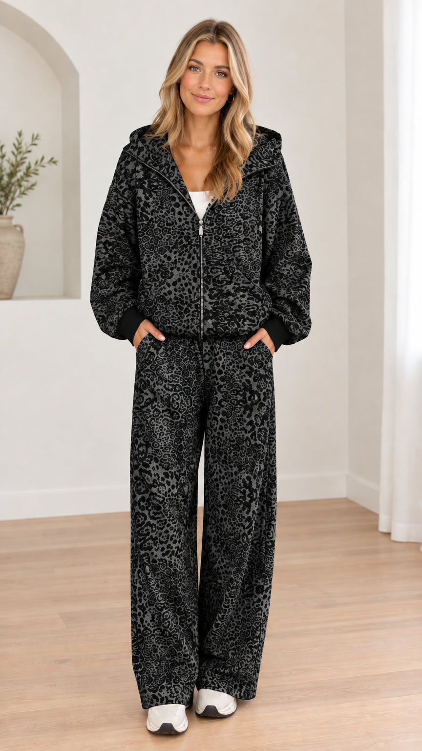 Woman wearing black leopard print hooded zip-up jacket and wide-leg pants set