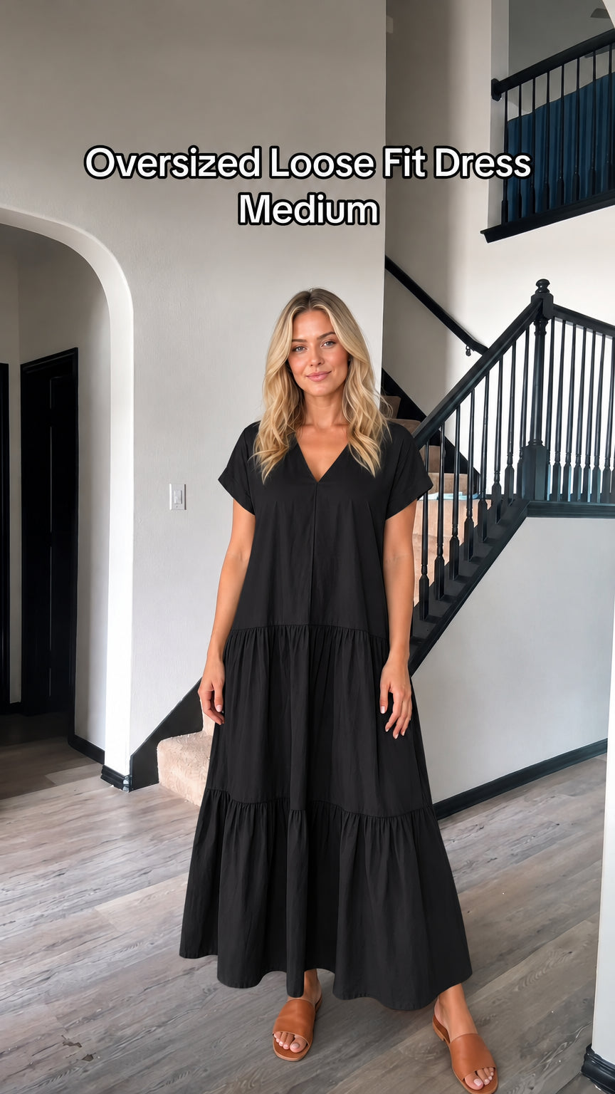 Front view of woman wearing oversized black V-neck tiered maxi dress