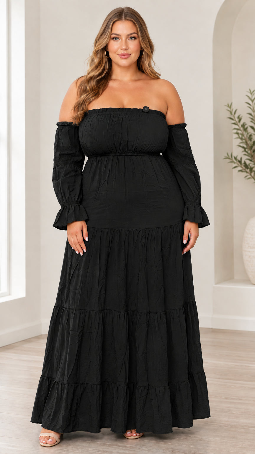 Front view of model wearing black off-the-shoulder tiered maxi dress