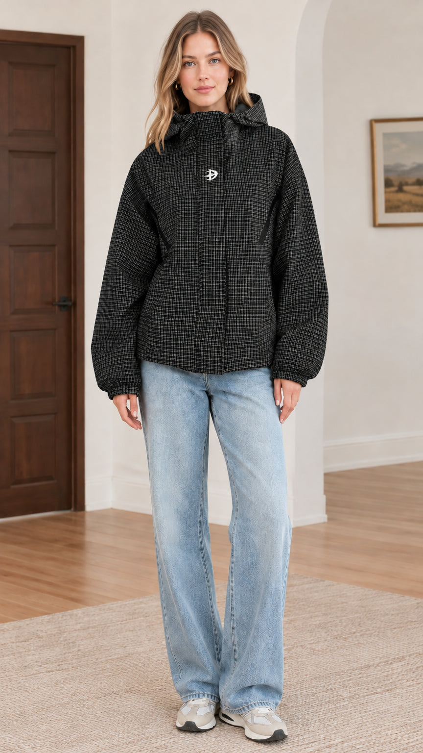 Front view of black houndstooth hooded jacket styled with light blue jeans