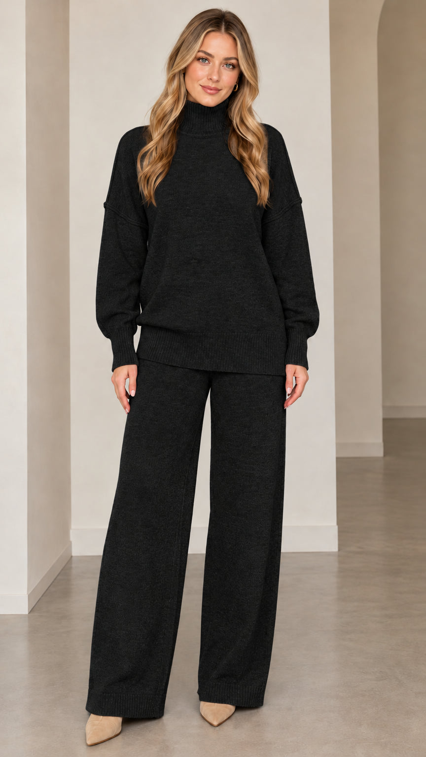 Front full-length view of model wearing black knit turtleneck sweater and matching wide-leg pants