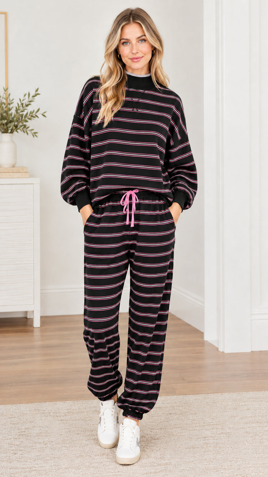 Woman wearing black and white striped 2-piece sweatshirt and jogger pants set