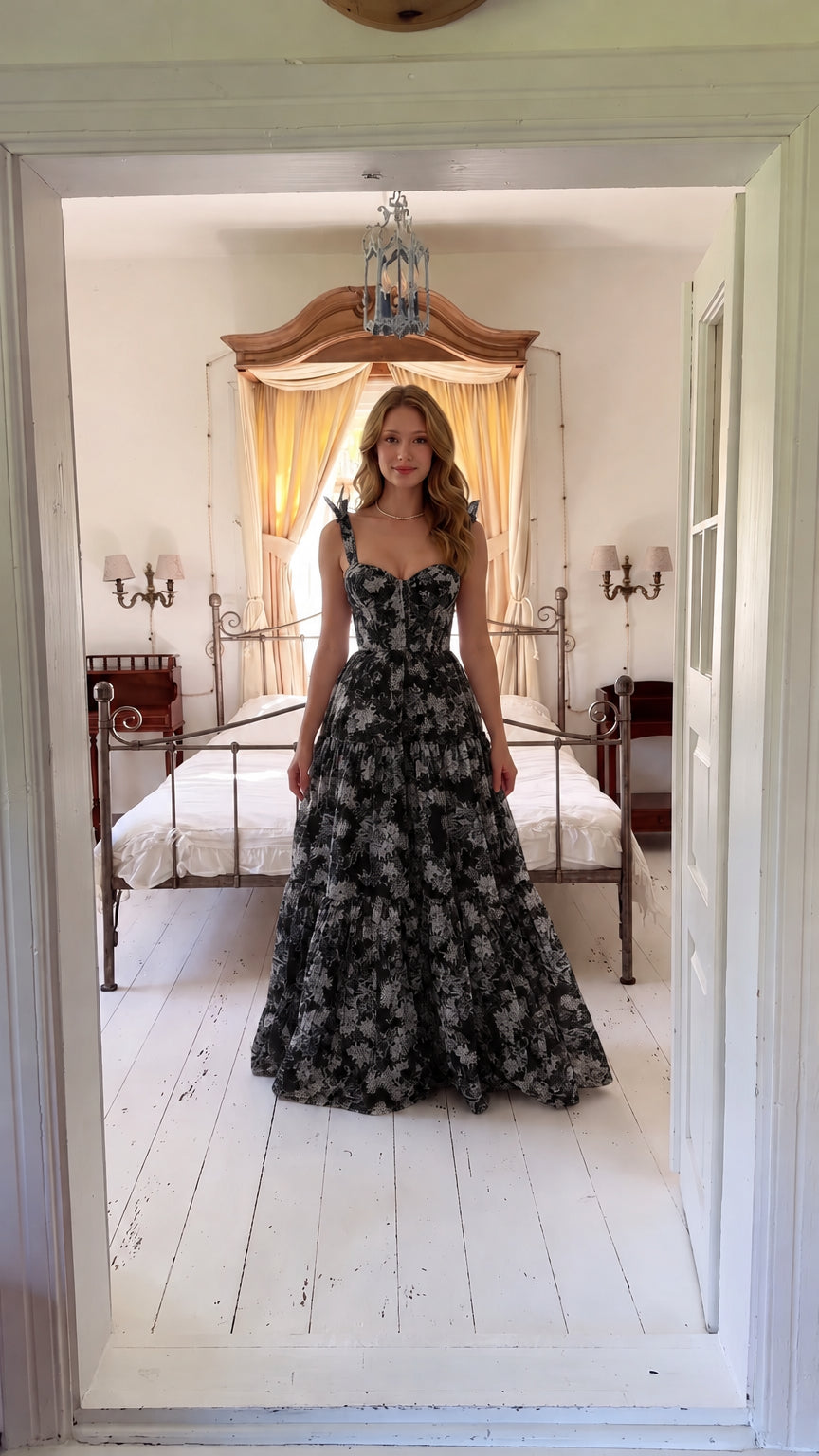 Front view of woman wearing black floral corset maxi dress with tie straps