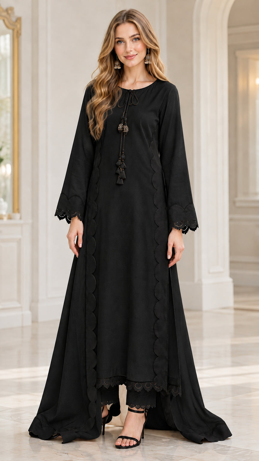 Front view of woman wearing black scallop trim high-low tunic and trouser set