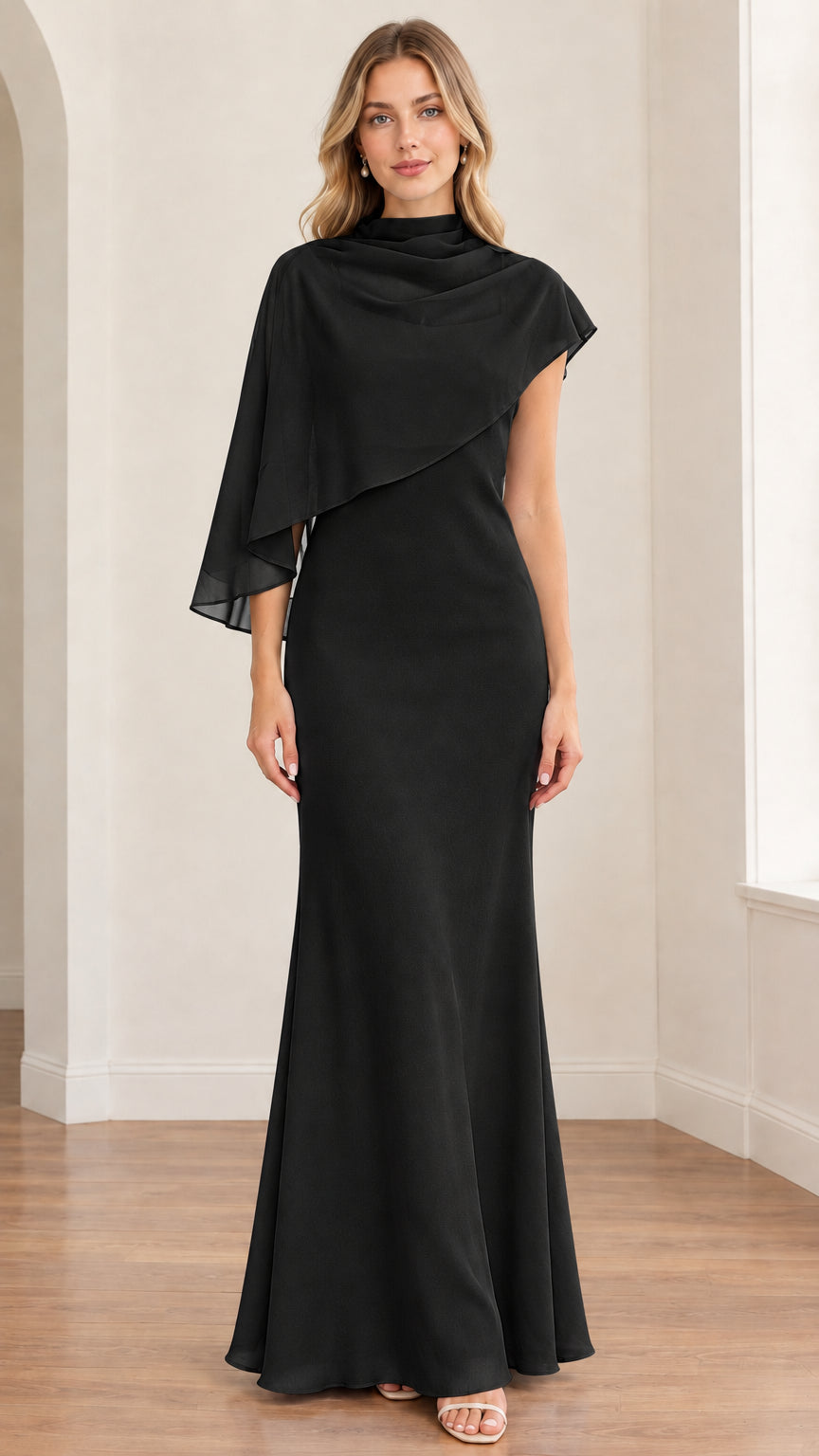 Front view of model wearing the black asymmetrical capelet formal maxi gown