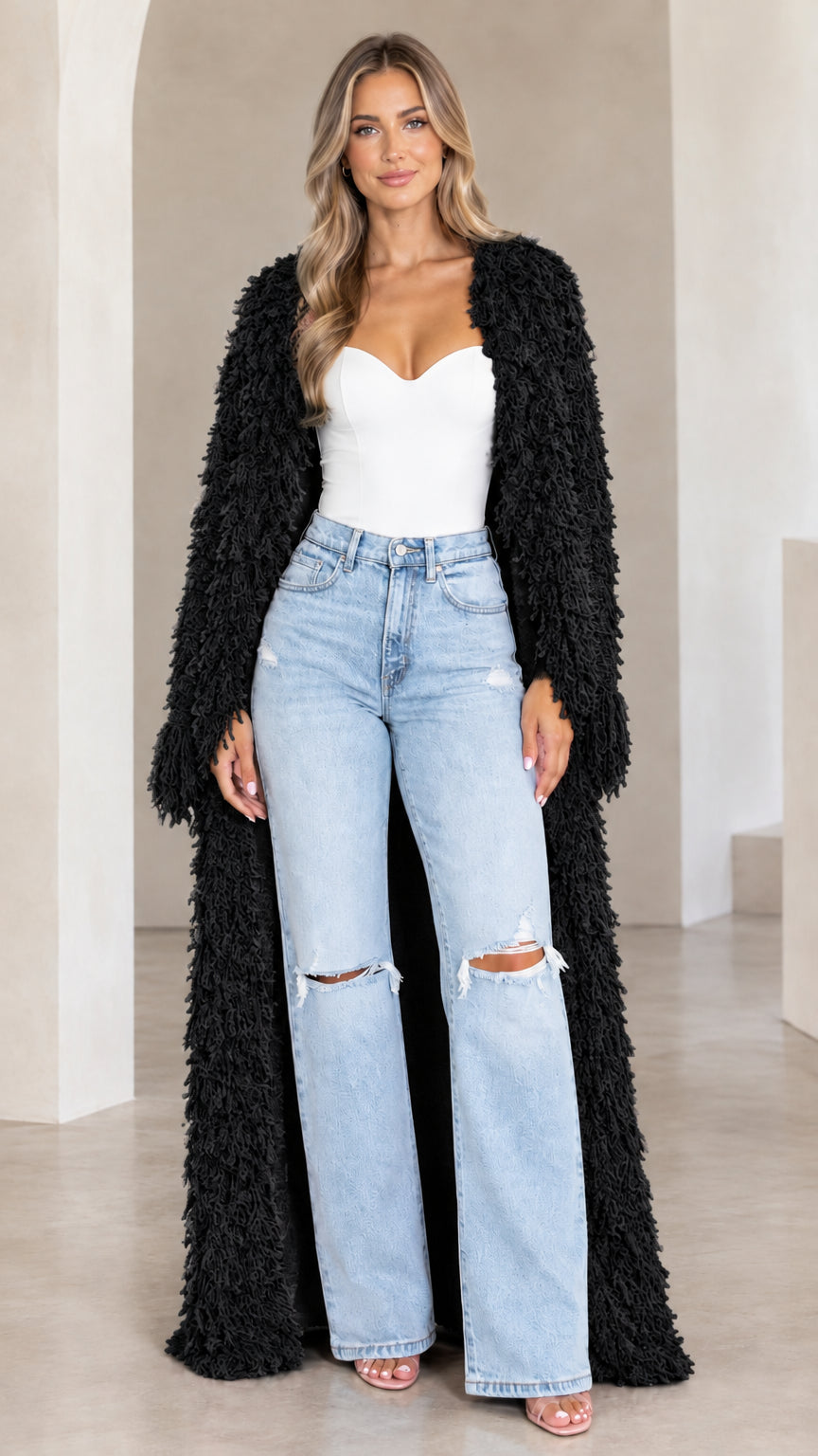 Front view of model wearing black textured shaggy maxi duster cardigan
