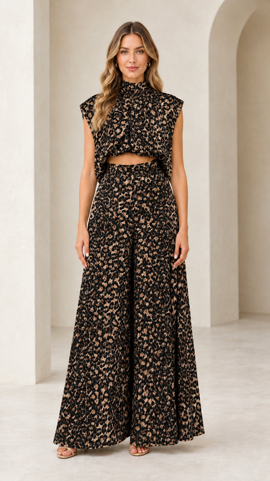 Front view of woman wearing black and cream leopard print mock neck top and wide-leg pants set