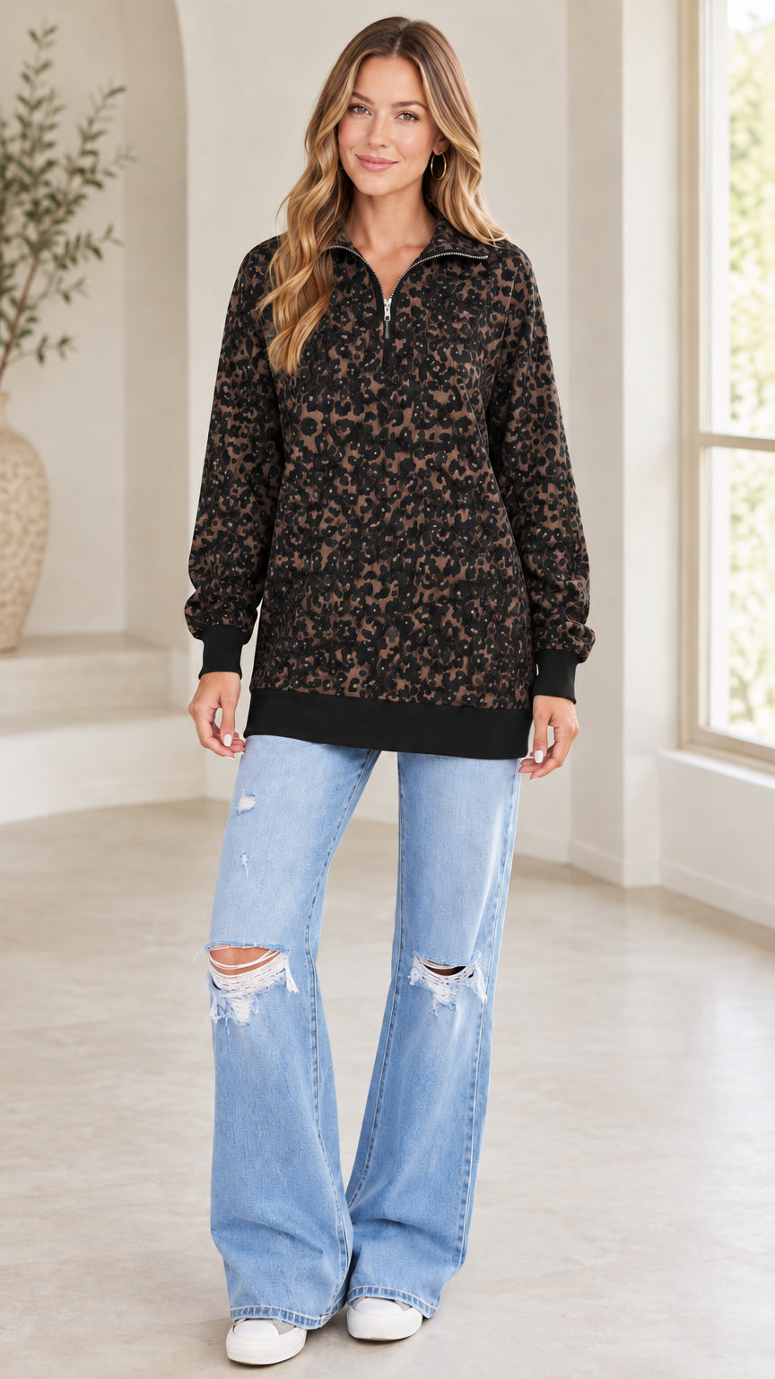 Model wearing black leopard print quarter-zip sweatshirt with distressed wide-leg jeans