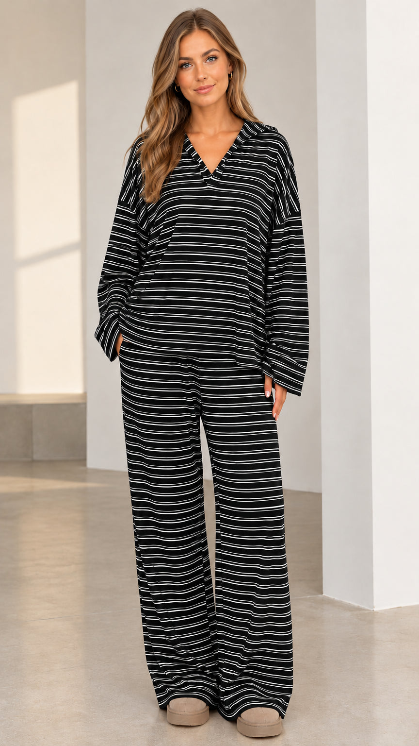 Woman wearing black and white striped long sleeve top and wide leg pants set