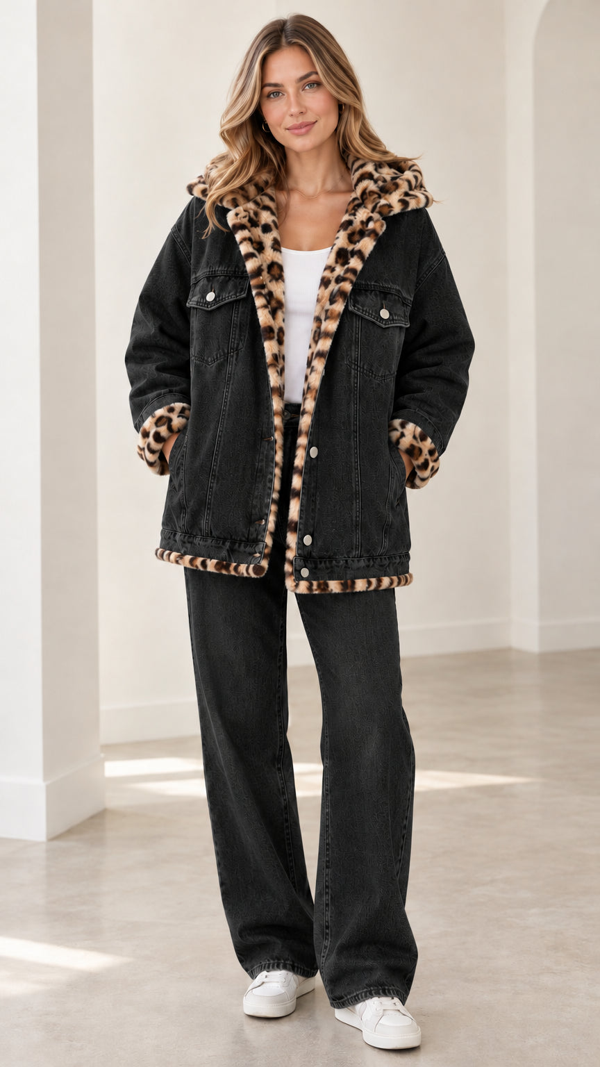 Model wearing washed black hooded denim jacket with leopard lining and matching black jeans