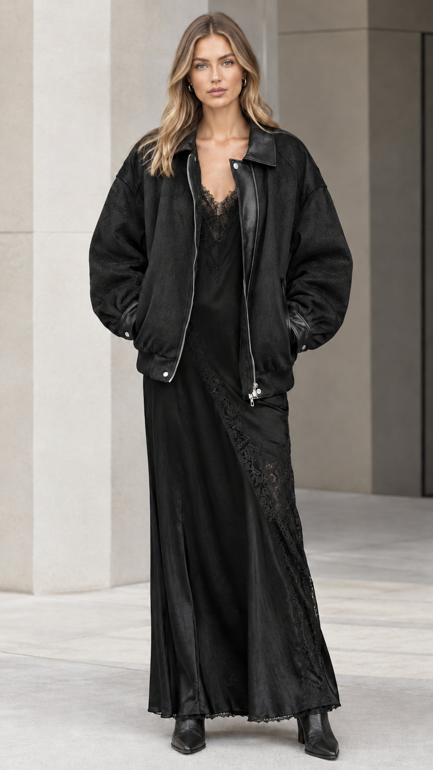 Model wearing black oversized bomber jacket and black lace-trim slip dress set