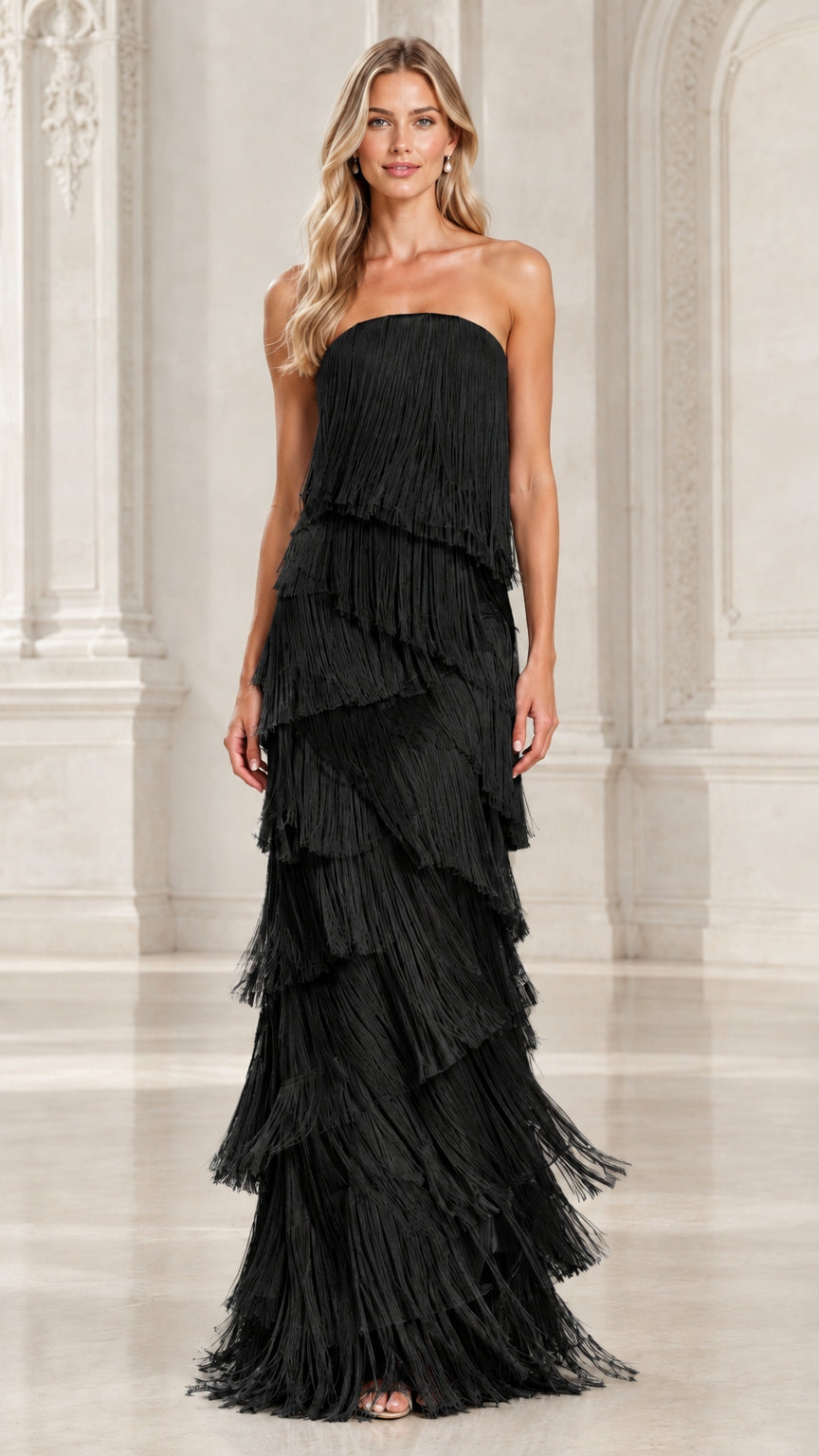 Full-length front view of model in black strapless tiered fringe maxi evening dress