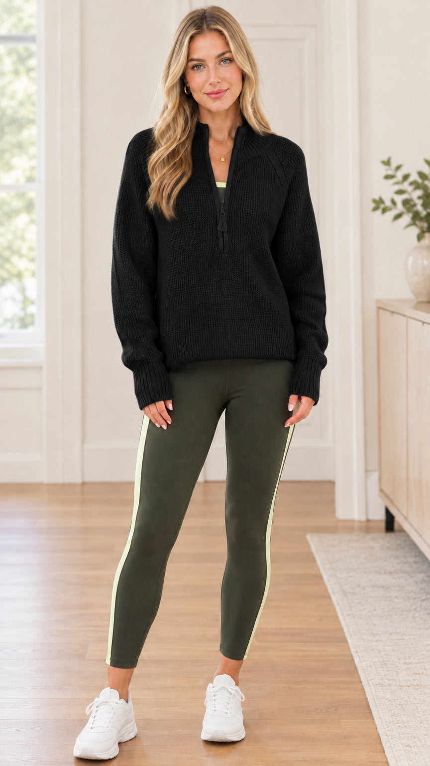 Front full-body view of model wearing black quarter-zip ribbed pullover sweater
