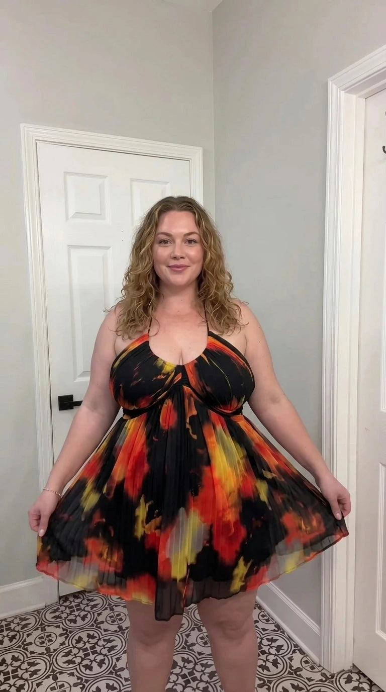 Front view of black and fire multi watercolor pleated halter babydoll dress