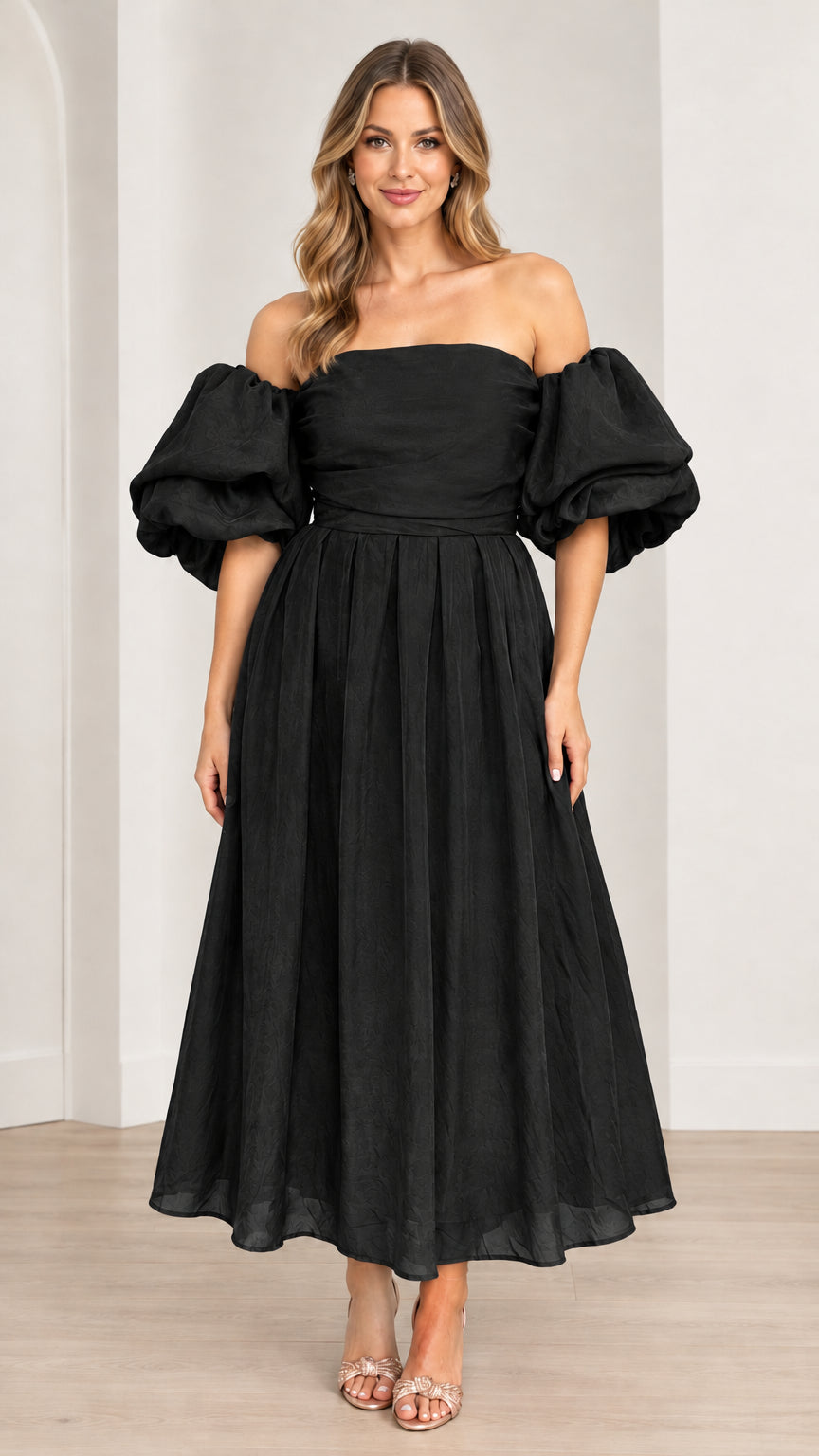 Model wearing off-the-shoulder puff sleeve pleated midi dress in black