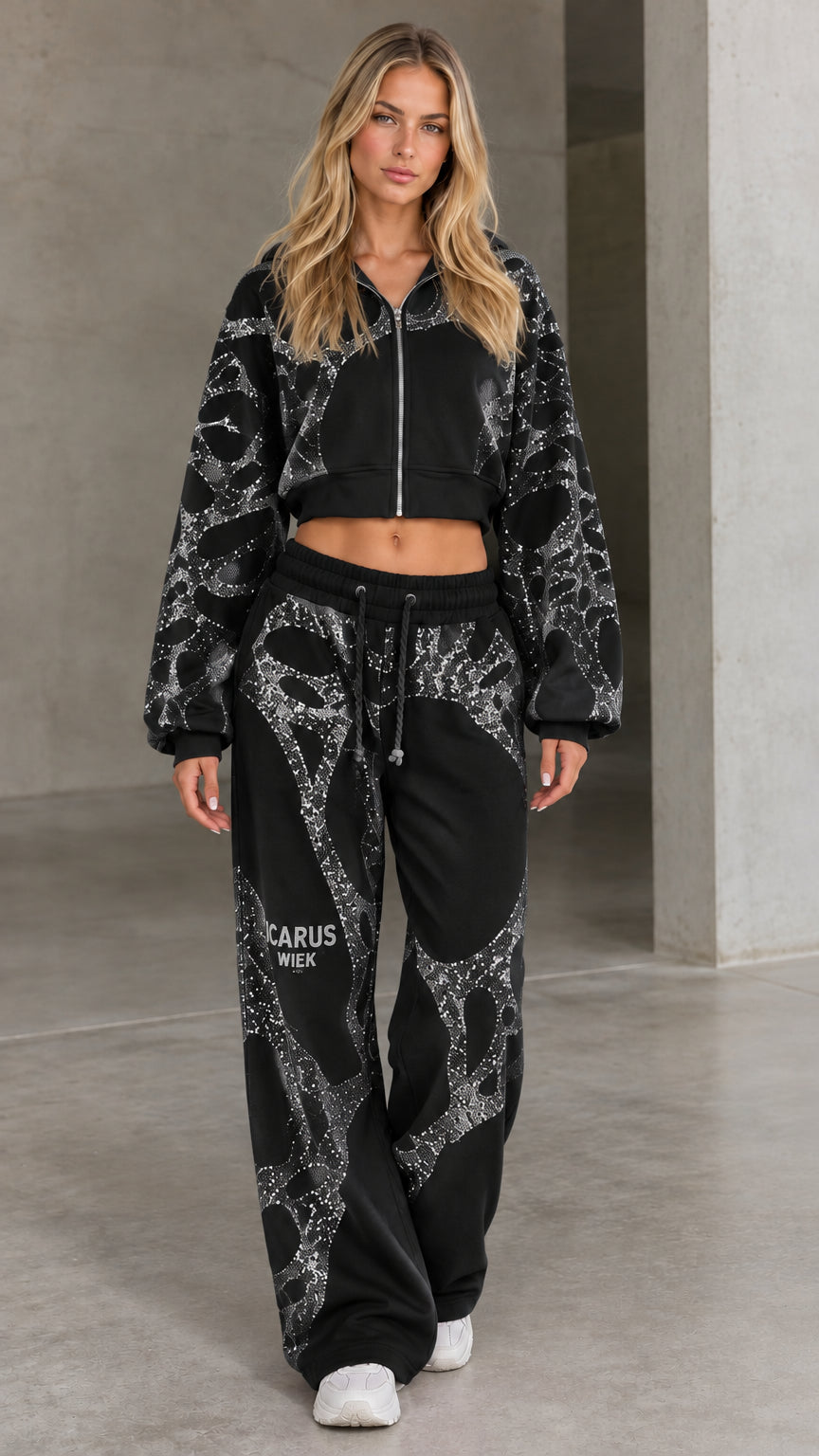Front view of woman wearing black rhinestone cropped zip-up hoodie and wide-leg pants set