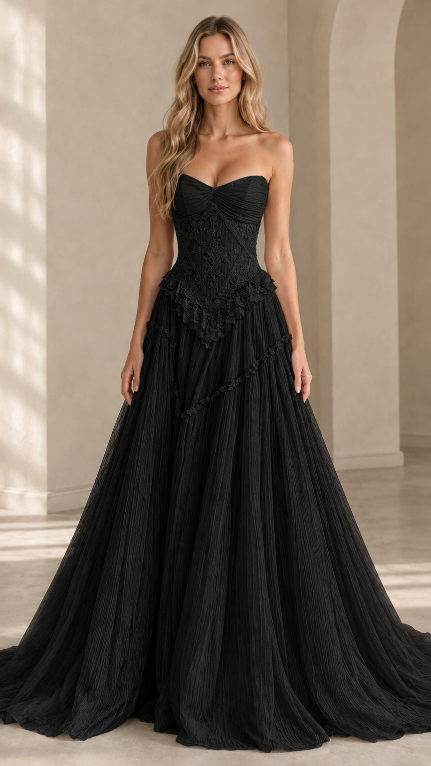 Front view of model wearing black strapless basque waist tulle evening gown
