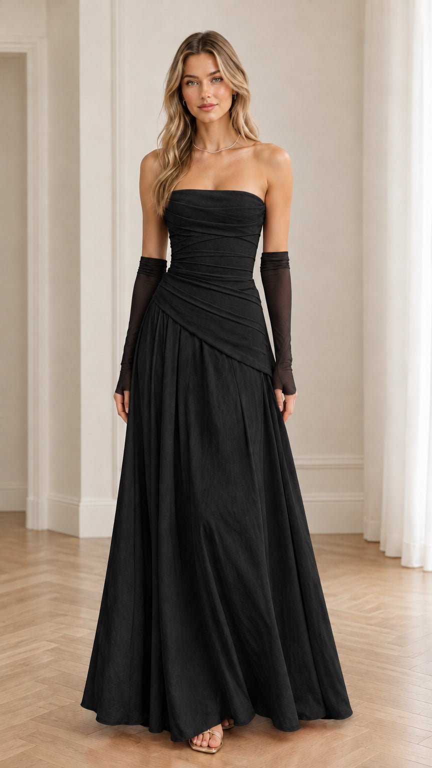Model wearing black strapless ruched evening gown with matching black sheer gloves