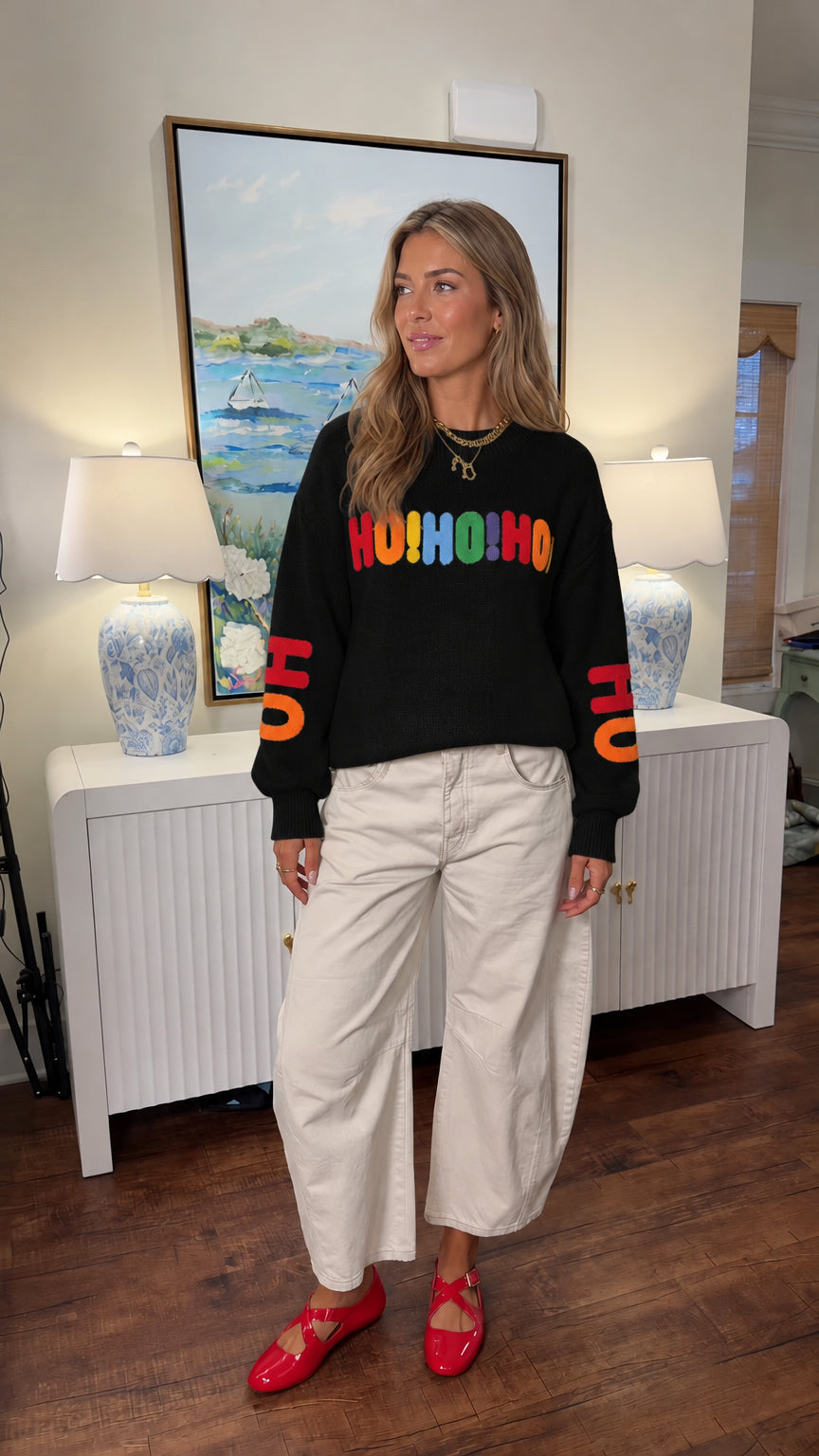 Woman wearing black Ho Ho Ho embroidered knit holiday sweater