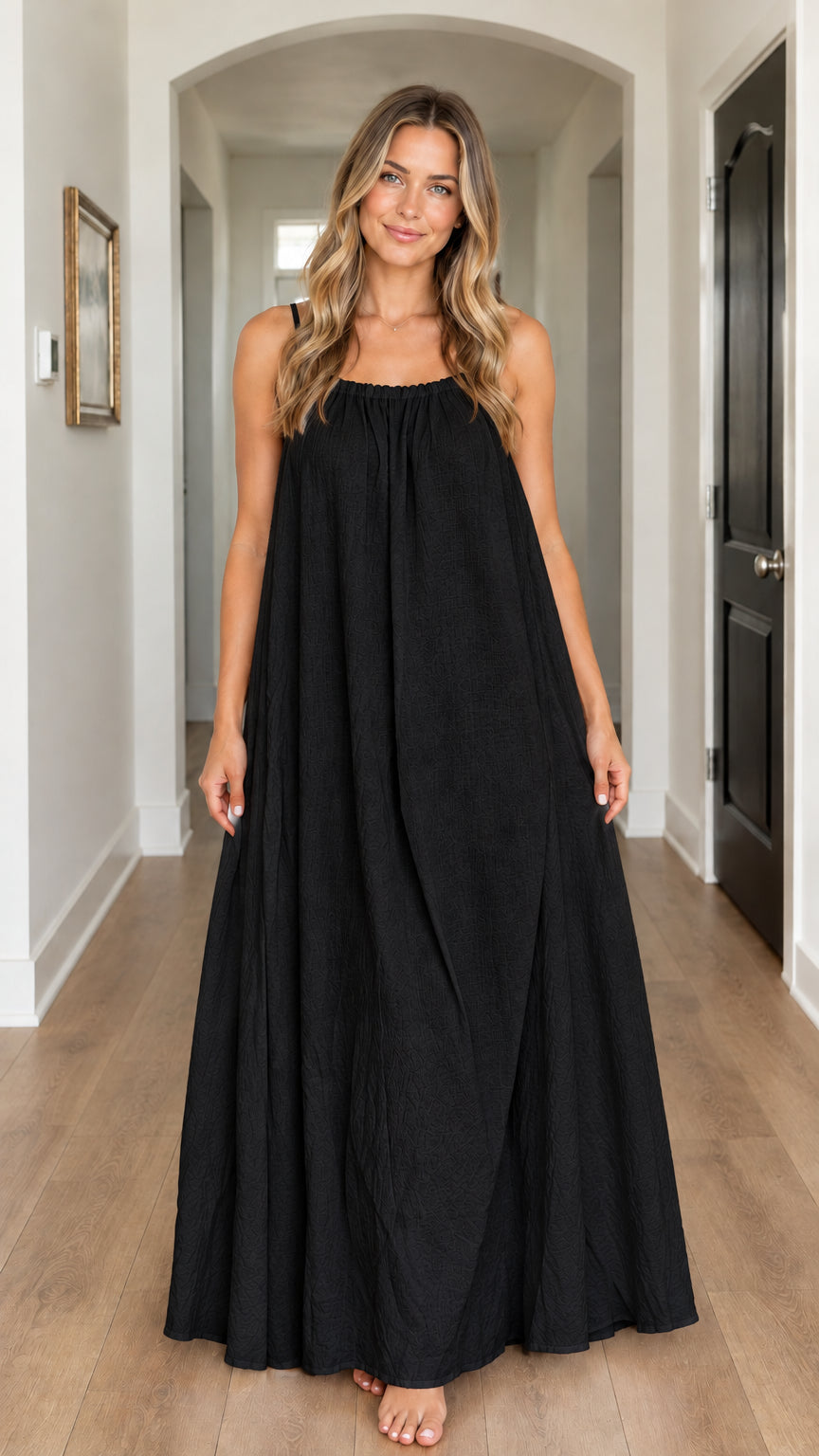 Model wearing black sleeveless gathered maxi dress