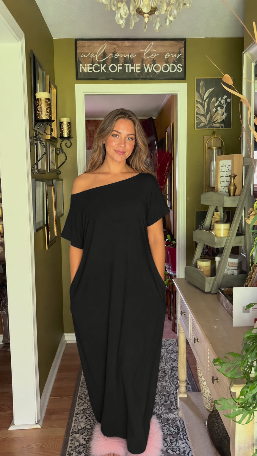 Front view of model wearing black one-shoulder loose maxi dress with pockets