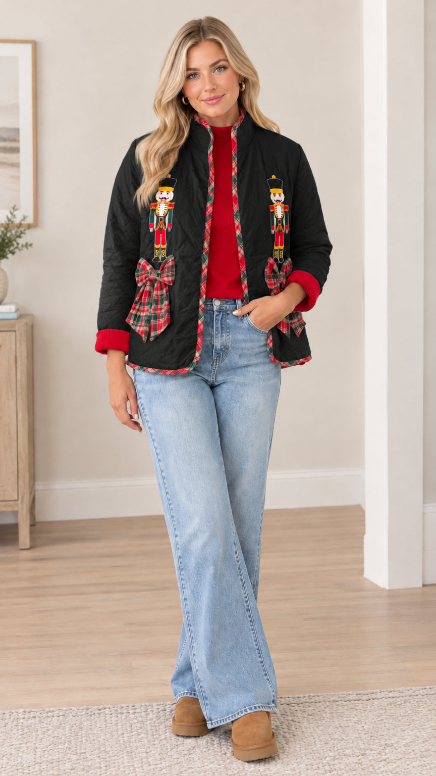 Model wearing black quilted holiday jacket with nutcracker embroidery