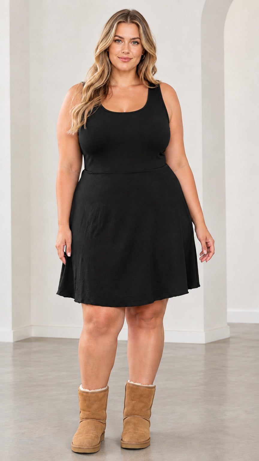 Front view of model wearing black sleeveless fit and flare mini skater dress
