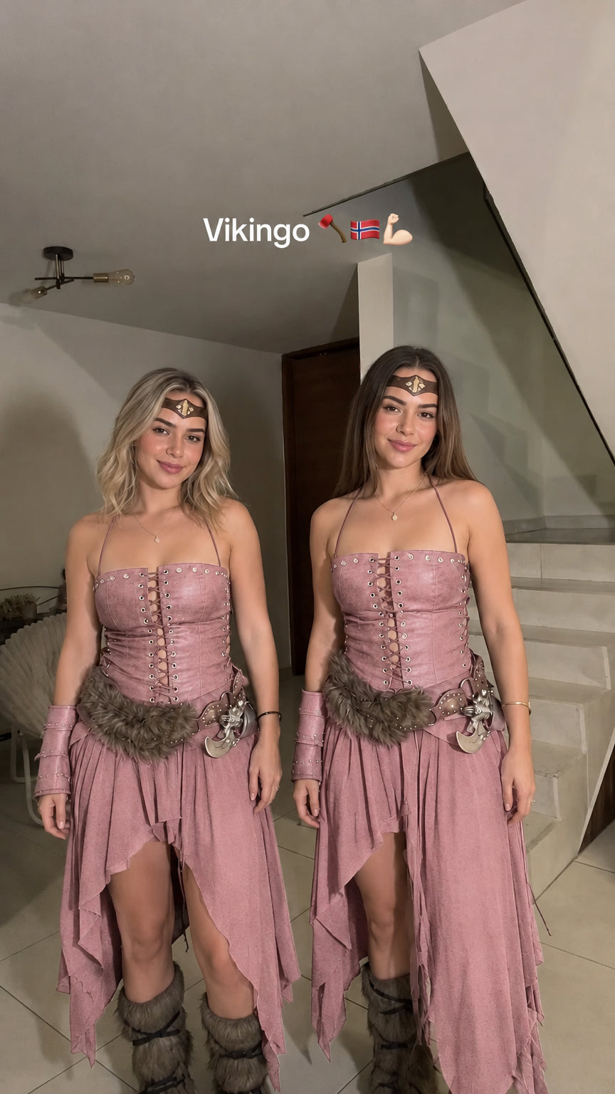 Two women modeling the dusty pink Viking warrior corset top and asymmetrical skirt costume set