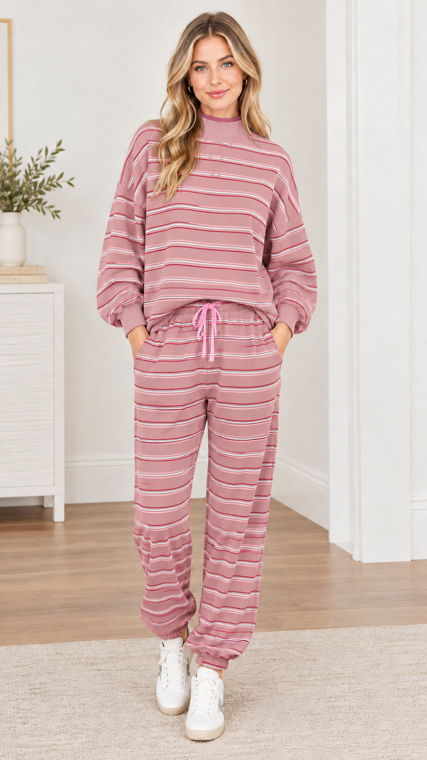Woman wearing dusty pink striped 2-piece sweatshirt and jogger pants set