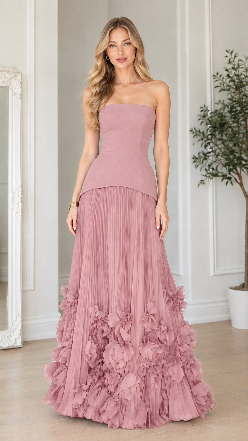 Front view of dusty pink strapless corset pleated maxi gown with 3D floral hem