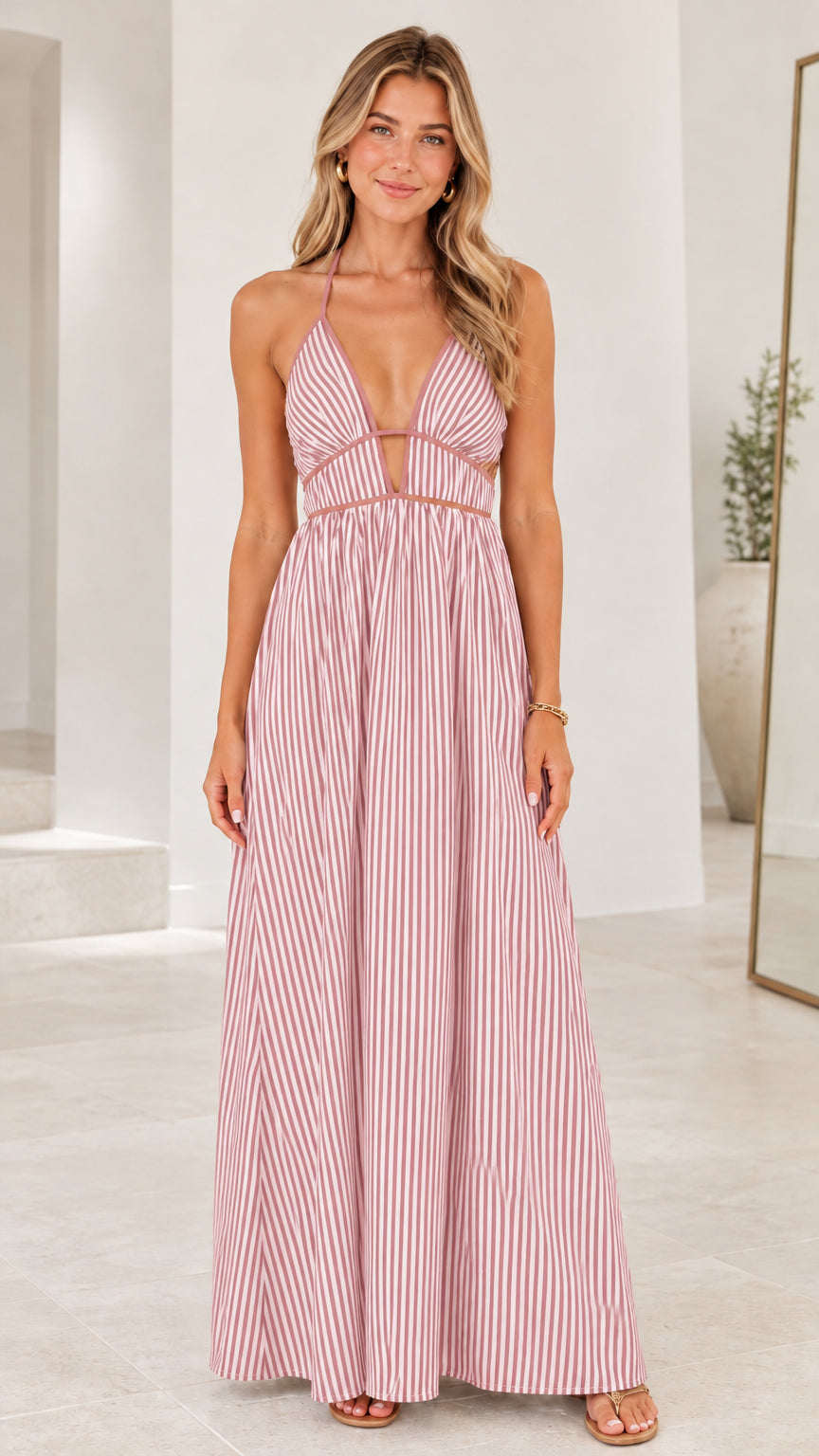 Front view of model wearing Pink striped halter cut-out maxi dress