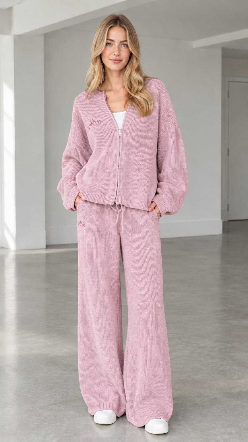 Front full view of woman wearing dusty pink ribbed knit zip-up cardigan and wide-leg pants set