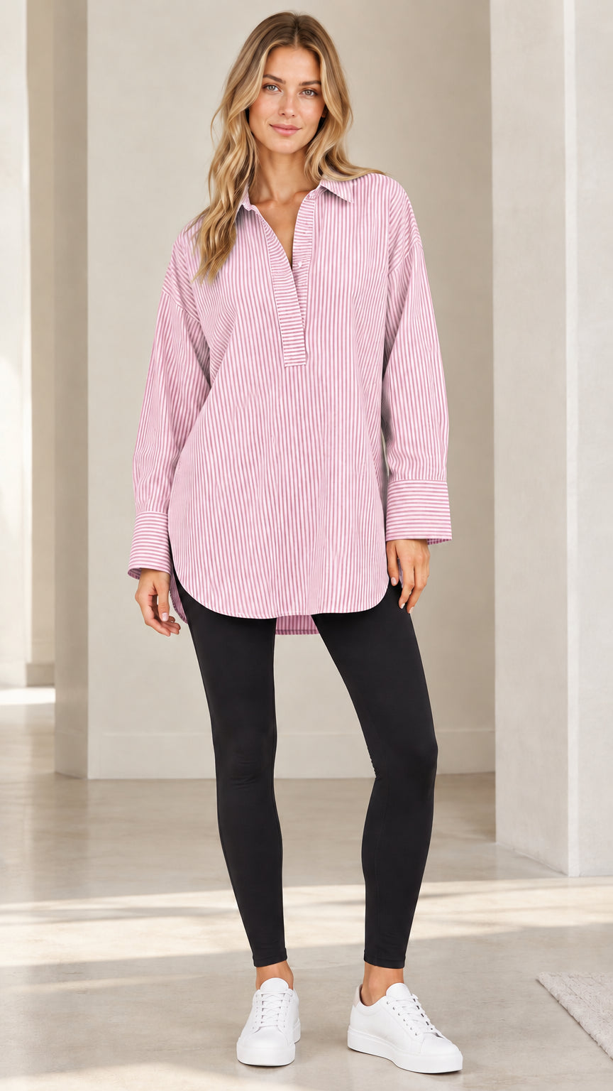 Front view of model wearing light pink and white vertical striped popover tunic shirt