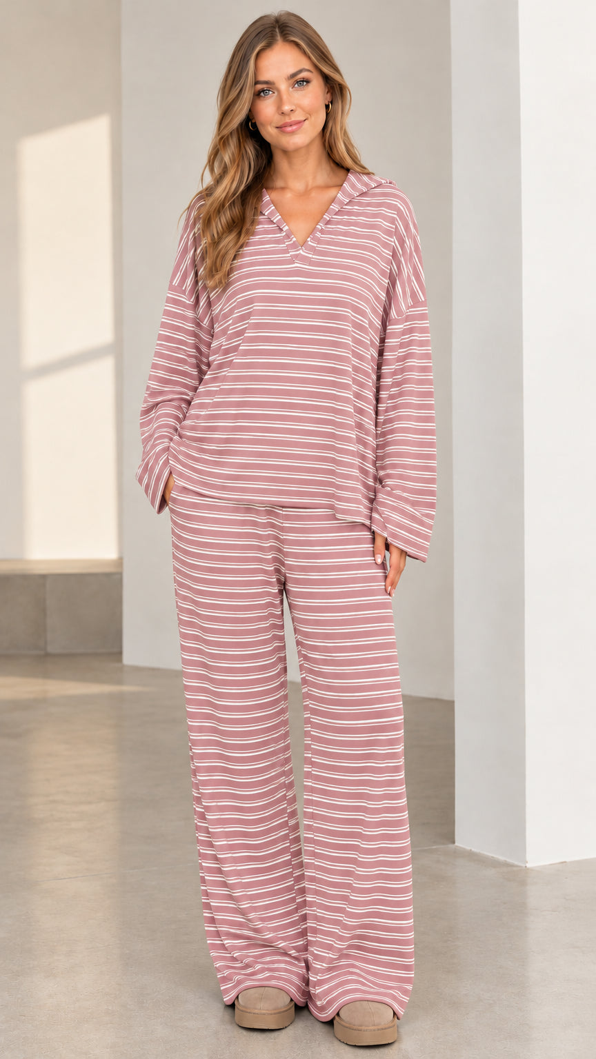 Woman wearing soft pink and white striped loungewear two-piece set