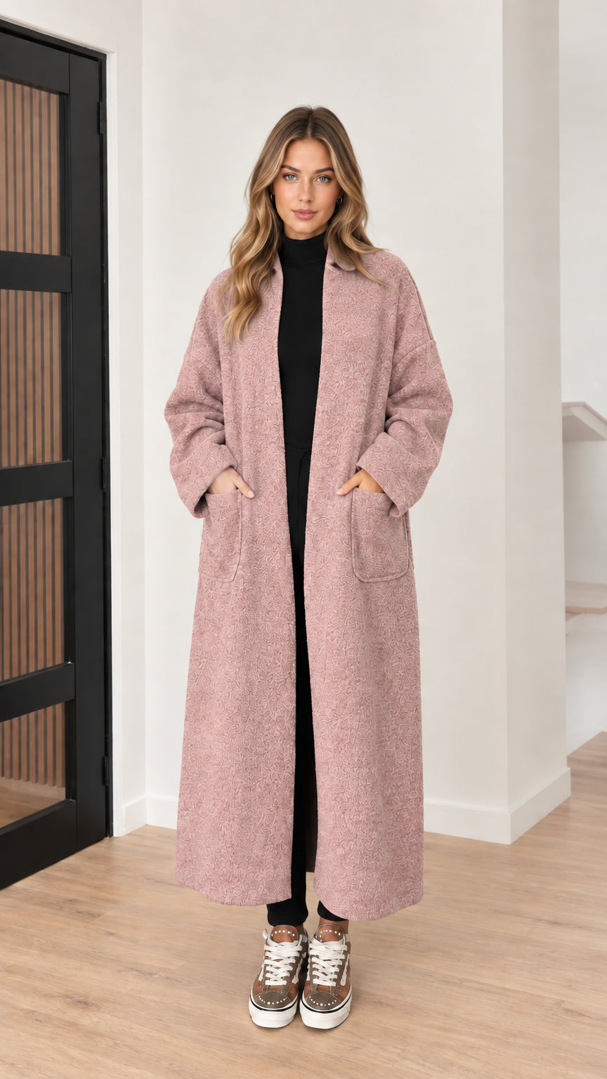 Front view of model wearing dusty pink textured longline coat