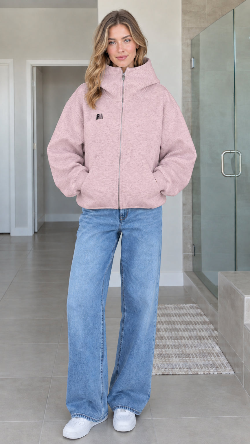 Front view of model wearing dusty pink oversized high-neck zip-up fleece hoodie jacket