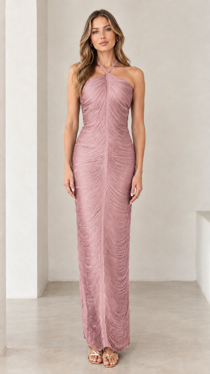 Front view of woman wearing dusty rose halter ruched backless maxi dress