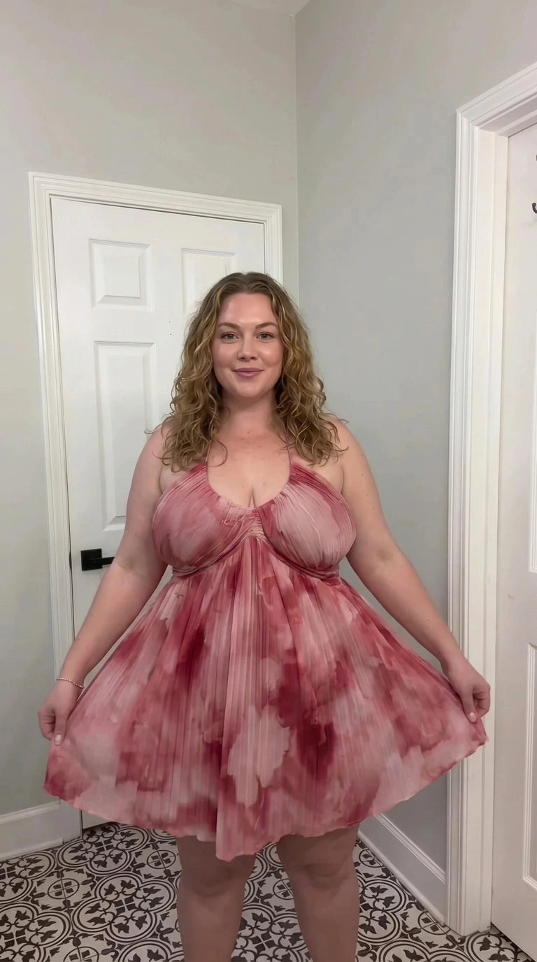 Front view of dusty rose multi watercolor pleated halter babydoll mini dress