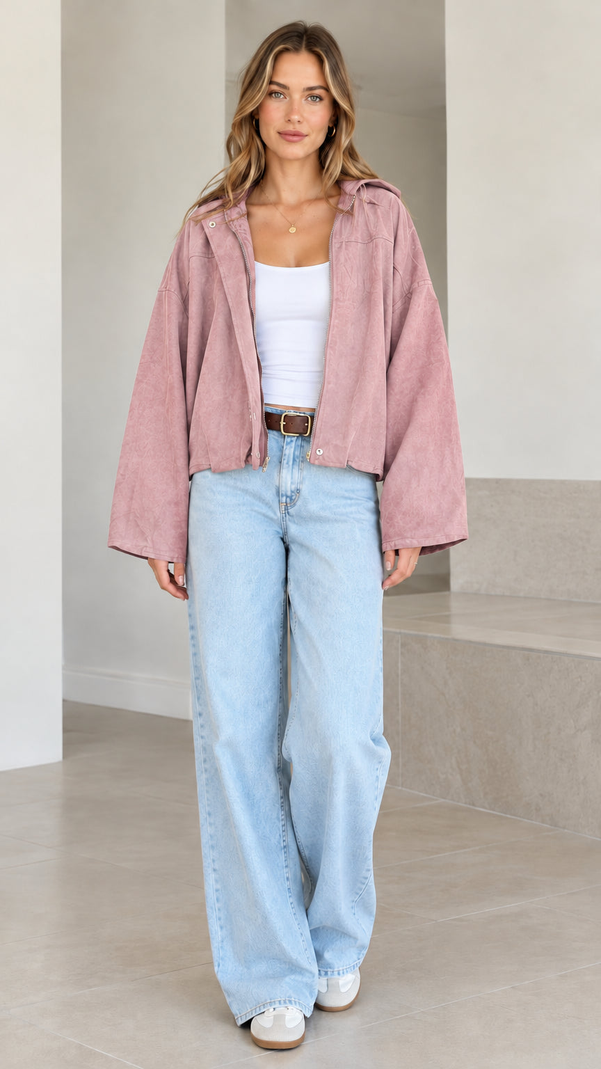 Model wearing dusty pink wide-sleeve cropped hooded jacket with front zip closure