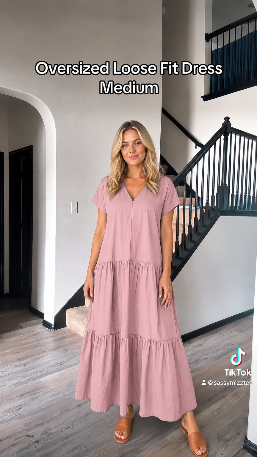 Front view of woman wearing dusty pink loose fit tiered maxi dress