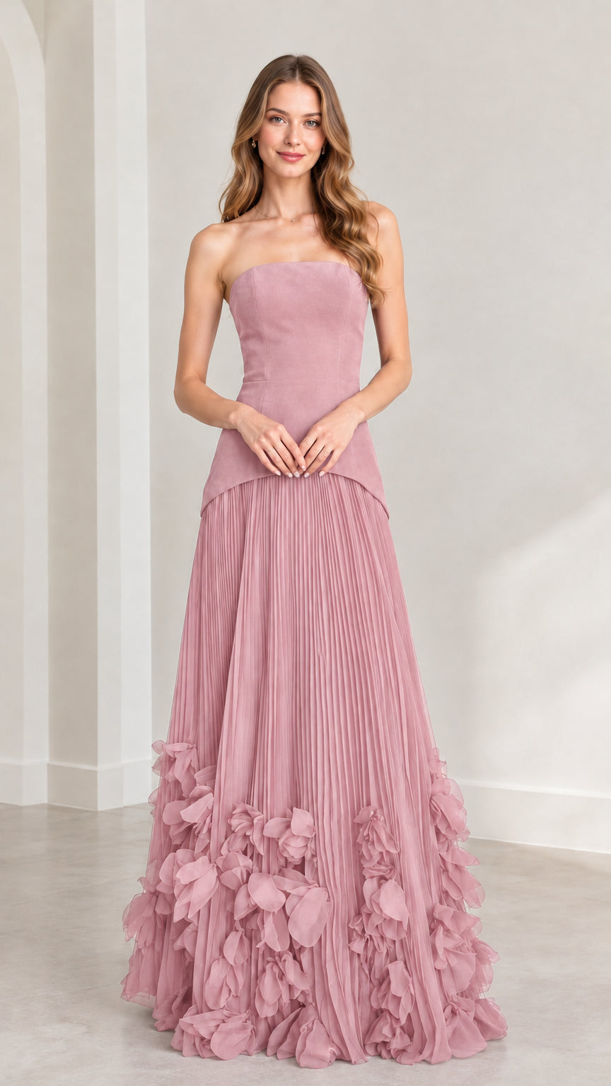 Front view of model wearing dusty rose pink strapless pleated maxi dress