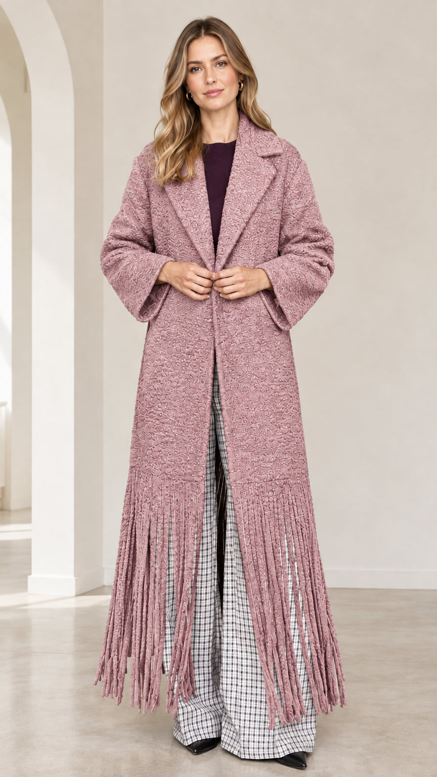 Front view of dusty rose pink textured bouclé maxi coat with fringe trim
