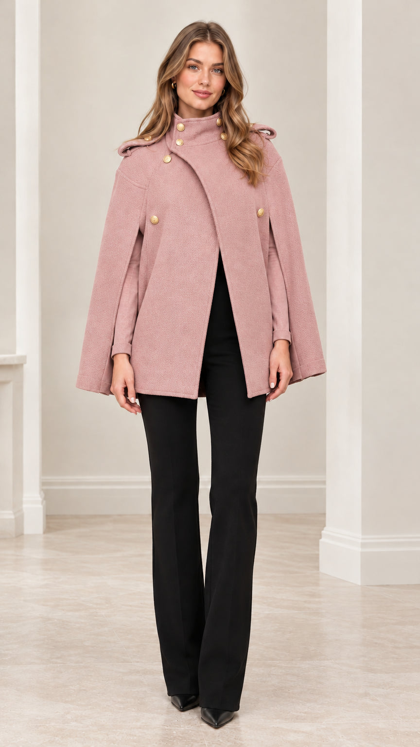 Front view of model wearing dusty pink military cape coat paired with black trousers