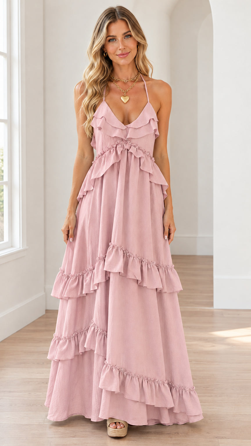 Front view of dusty pink tiered ruffle halter maxi dress on model