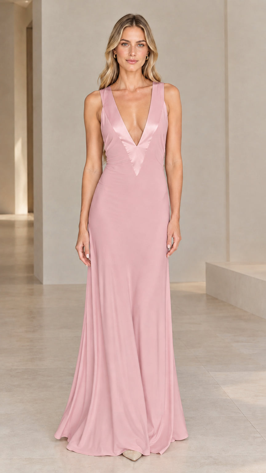 Front view of model wearing dusty pink sleeveless V-neck evening gown with satin trim