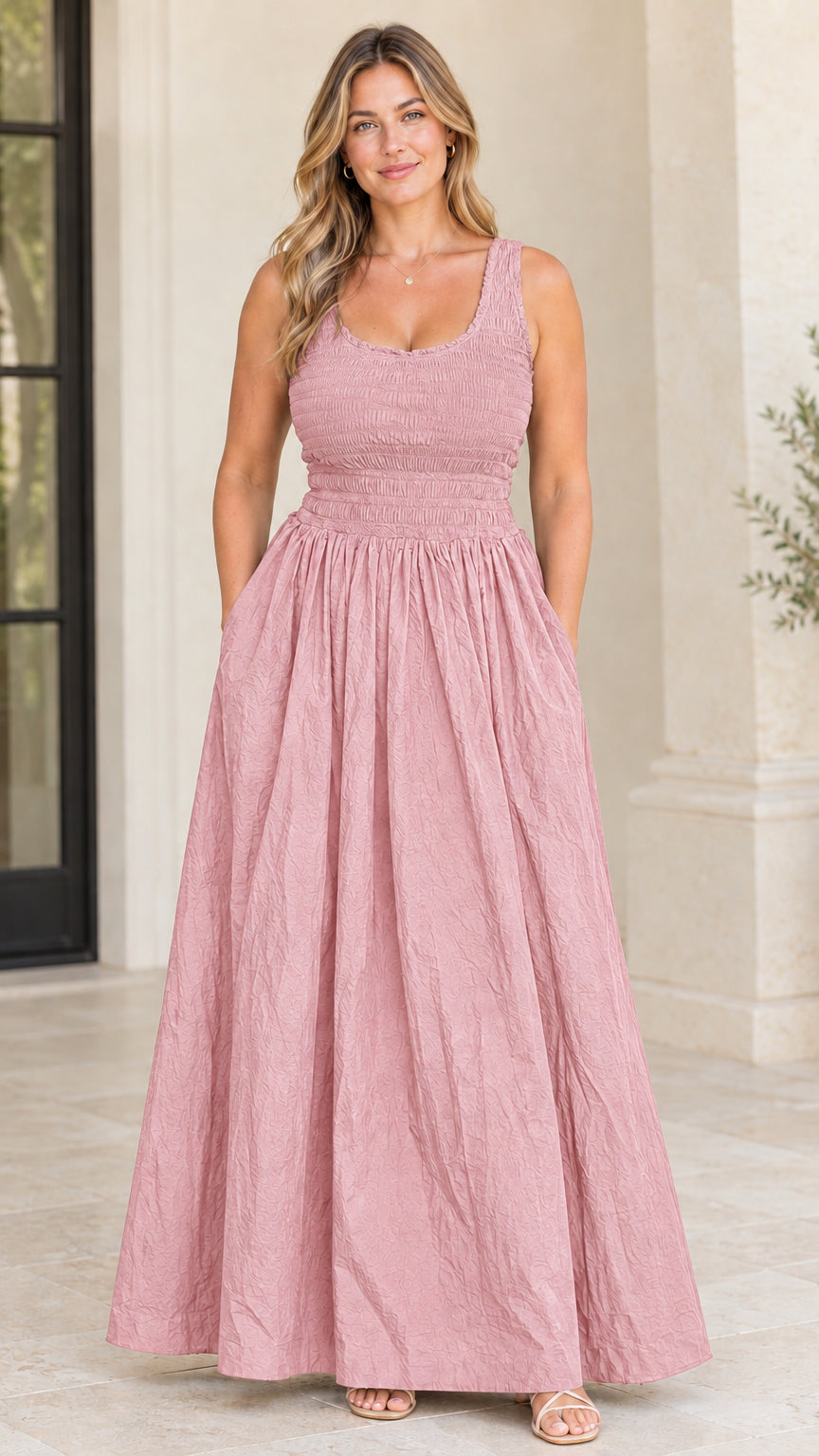 Model wearing dusty pink sleeveless smocked bodice maxi dress with pockets