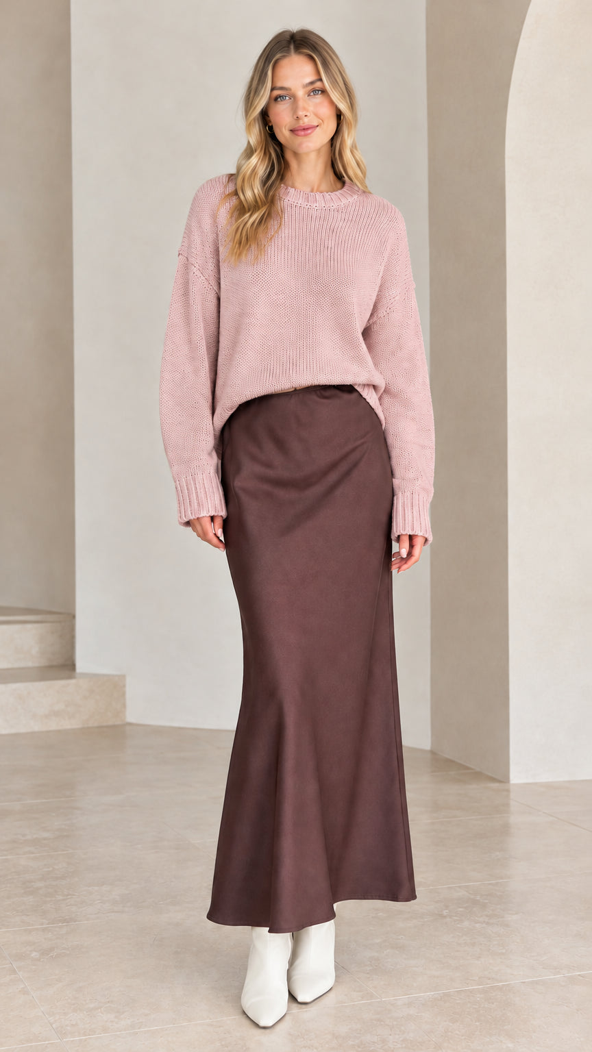 Model wearing dusty pink drop shoulder knit sweater with brown satin skirt